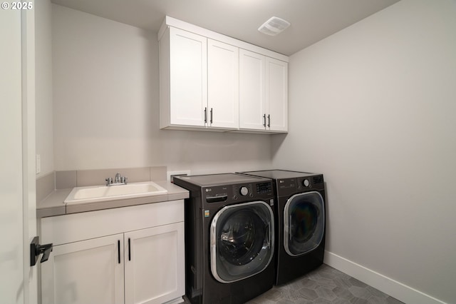 washroom with cabinets, sink, washer and clothes dryer, and tile patterned flooring