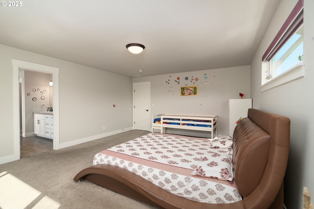 carpeted bedroom featuring ensuite bath