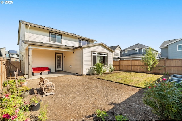 rear view of property with a lawn and a patio