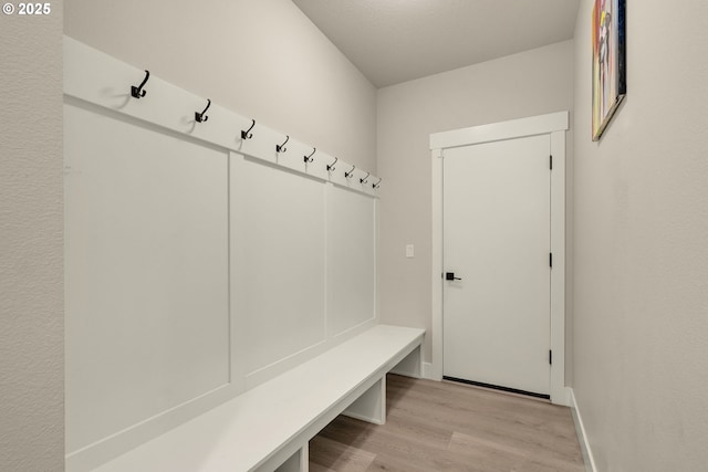 mudroom with light hardwood / wood-style floors