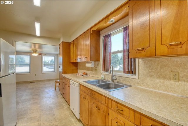 3103 SW Kirk Ave, Pendleton, OR 97801 - kitchen featuring white appliances, light countertops, brown cabinetry, ceiling fan, and tasteful backsplash