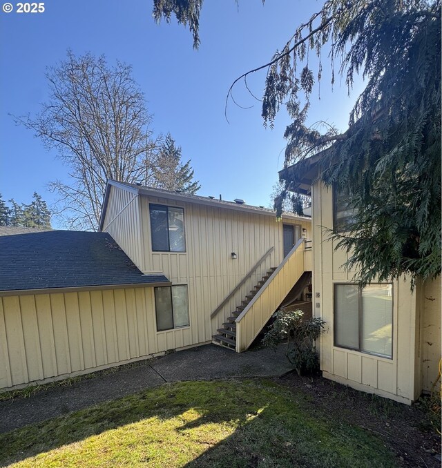 back of house with a lawn