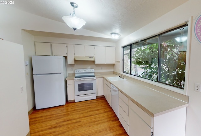 kitchen featuring sink, white appliances, white cabinets, decorative light fixtures, and light wood-type flooring