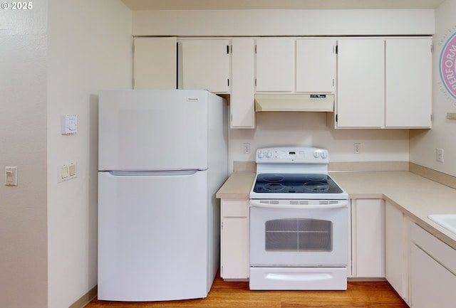 kitchen with white cabinets, white appliances, and light hardwood / wood-style floors