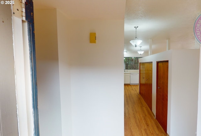 hall with light hardwood / wood-style floors