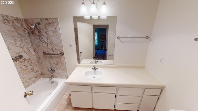 bathroom featuring tiled shower / bath combo and vanity