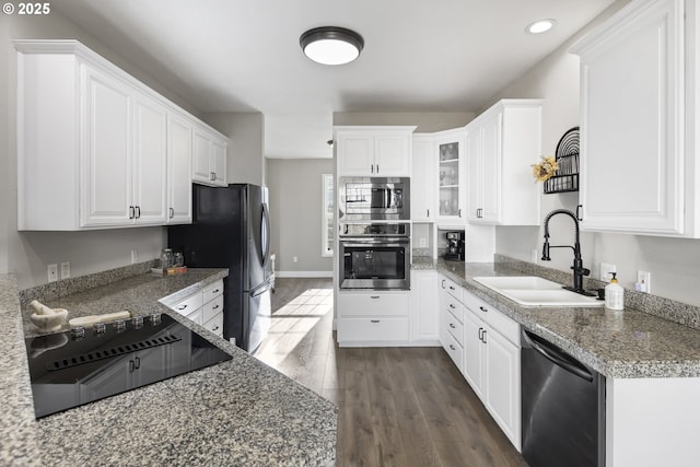 kitchen featuring stainless steel appliances, dark hardwood / wood-style flooring, sink, and white cabinets