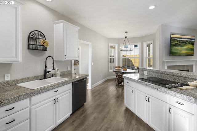 kitchen with pendant lighting, white cabinetry, sink, black appliances, and dark wood-type flooring