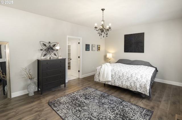 bedroom featuring dark hardwood / wood-style flooring and a chandelier