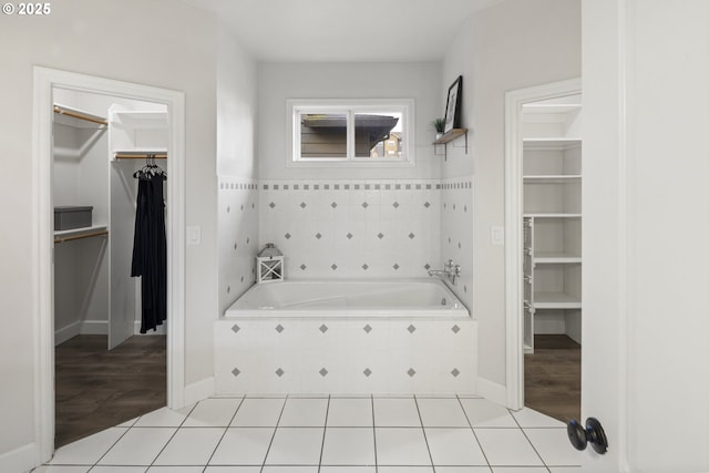 bathroom featuring tiled tub and tile patterned floors