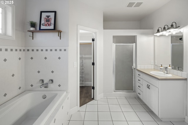 bathroom with tile patterned flooring, vanity, and shower with separate bathtub