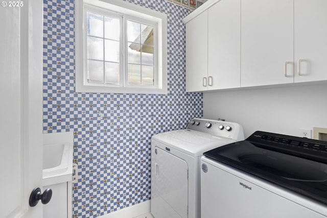 laundry room featuring cabinets and separate washer and dryer