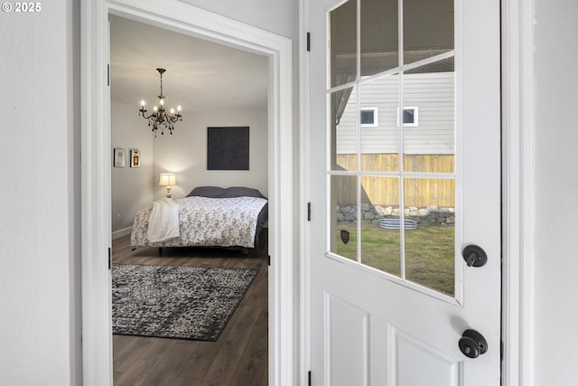 bedroom featuring hardwood / wood-style floors and a notable chandelier