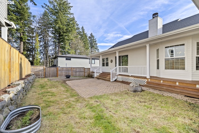 rear view of house with a patio area and a lawn