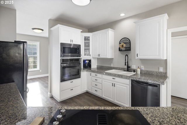 kitchen with appliances with stainless steel finishes, sink, white cabinets, and dark hardwood / wood-style flooring