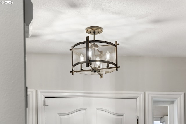 room details featuring a notable chandelier and a textured ceiling