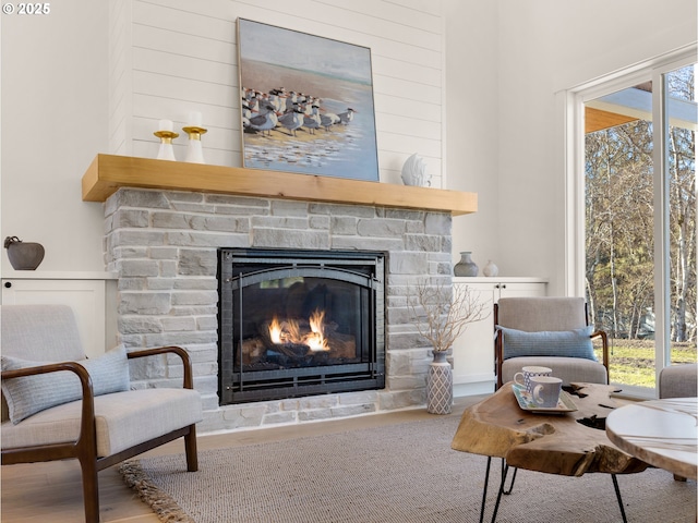 sitting room featuring a stone fireplace