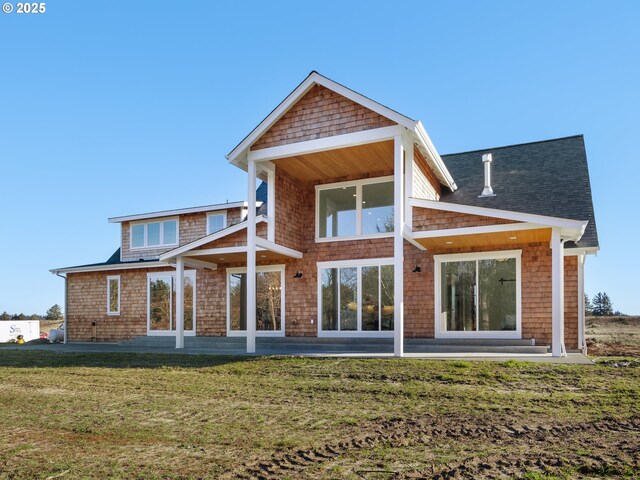 rear view of house featuring a yard and a patio area