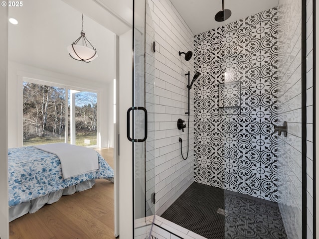 bathroom featuring wood-type flooring and a shower with shower door