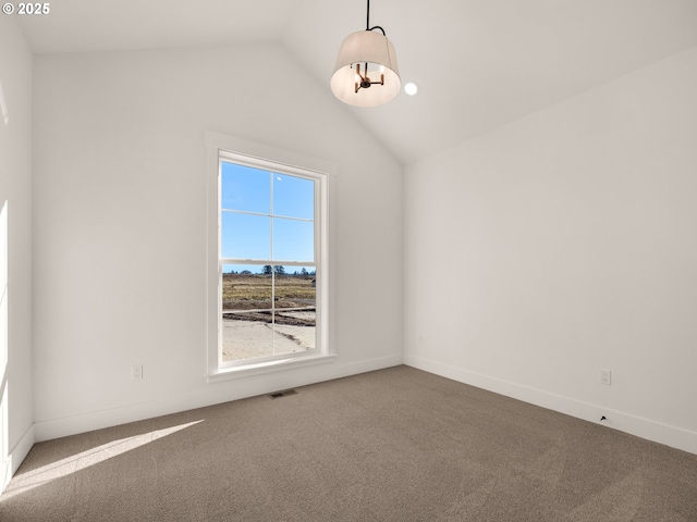 unfurnished room with carpet floors and vaulted ceiling