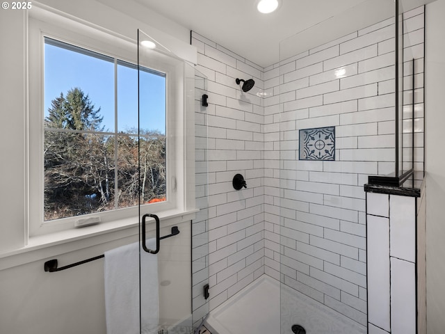 bathroom with a shower with shower door