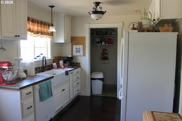 1407 9th St, Baker City, OR 97814 - kitchen with white appliances, a sink, dark countertops, white cabinets, and decorative light fixtures