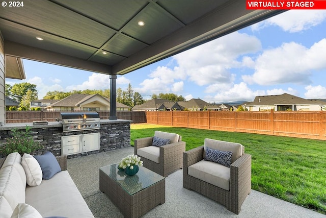 view of patio / terrace with an outdoor hangout area, a grill, and exterior kitchen