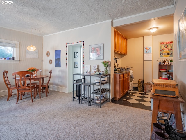 kitchen featuring gas range, ornamental molding, a textured ceiling, and dark colored carpet