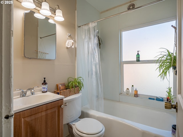 full bathroom with vanity, shower / tub combo, and toilet