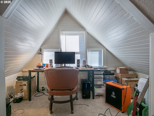 office with lofted ceiling, light carpet, and wooden walls