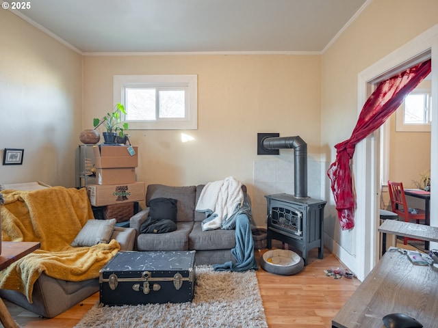 living room featuring crown molding, wood-type flooring, and a healthy amount of sunlight