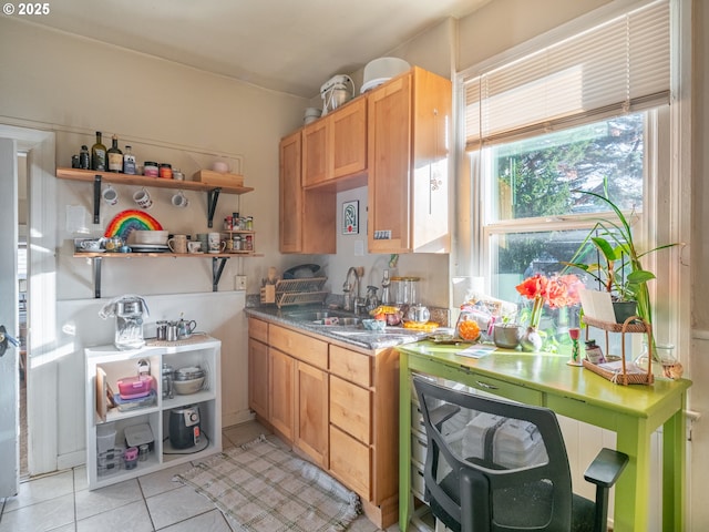 kitchen featuring sink and light tile patterned flooring