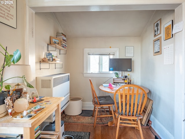 dining room with heating unit and hardwood / wood-style floors