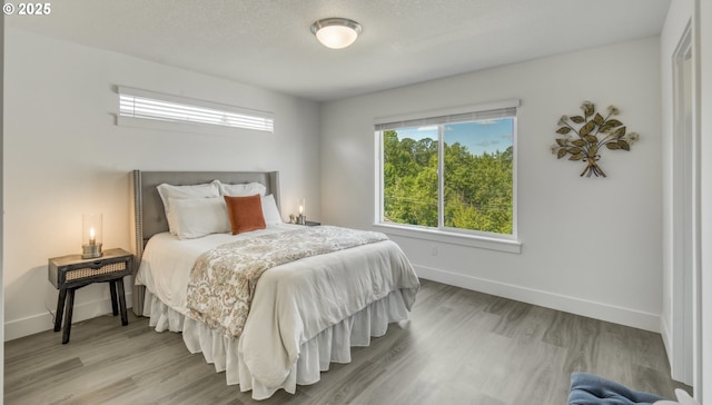 3037 SW Sherman Pl, Beaverton, OR 97003 - bedroom featuring baseboards and light wood-type flooring