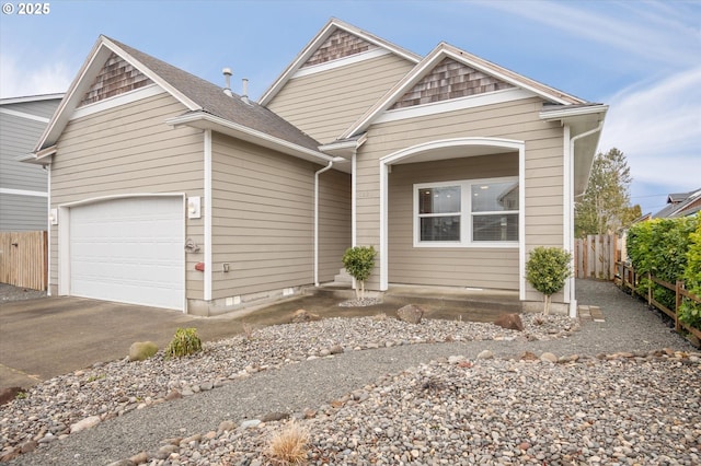 view of front of house with a garage, driveway, and fence