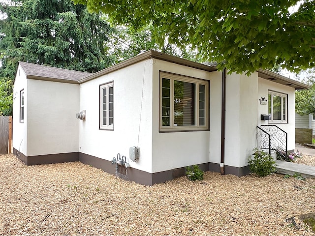 view of side of property featuring stucco siding