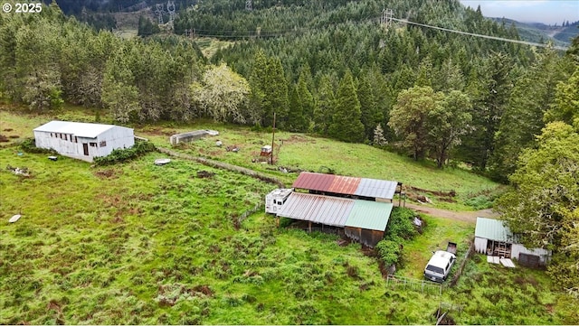 birds eye view of property with a wooded view