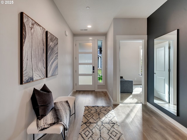 foyer with recessed lighting, wood finished floors, and baseboards