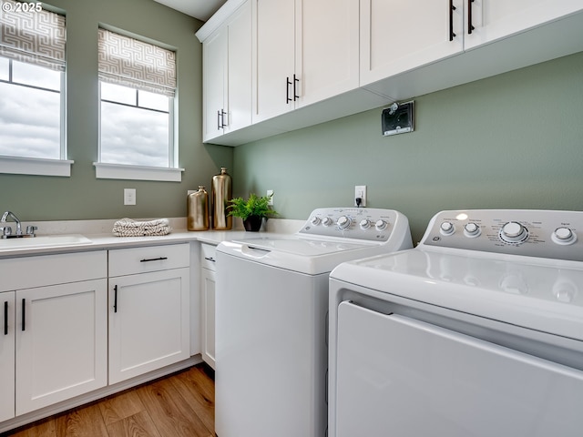 13009 NE 111th St, Vancouver, WA 98682 - washroom featuring washer and clothes dryer, cabinet space, and light wood-type flooring