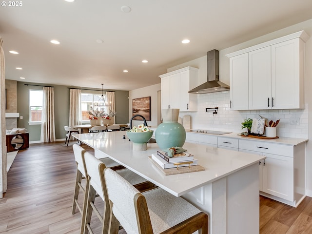 13009 NE 111th St, Vancouver, WA 98682 - kitchen with wall chimney exhaust hood, tasteful backsplash, light wood-style floors, light countertops, and recessed lighting