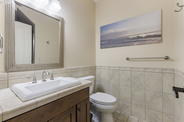 10137 SW Lancaster Rd, Portland, OR 97219 - bathroom featuring tile walls, vanity, wainscoting, and tile patterned floors