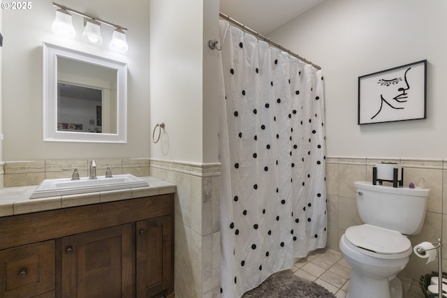 10137 SW Lancaster Rd, Portland, OR 97219 - bathroom featuring tile walls, a wainscoted wall, vanity, tile patterned flooring, and curtained shower