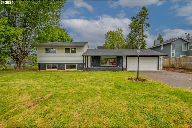 tri-level home with a front lawn and a garage