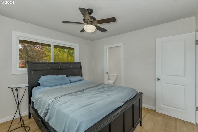 bedroom with ceiling fan, connected bathroom, and light hardwood / wood-style flooring