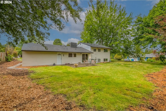 back of property featuring a patio area and a lawn