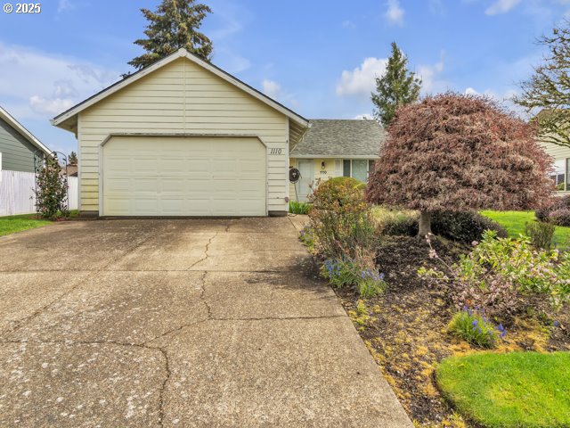 ranch-style home with driveway and a garage