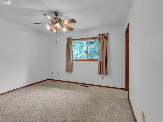 unfurnished room with baseboards, visible vents, ceiling fan, and carpet flooring