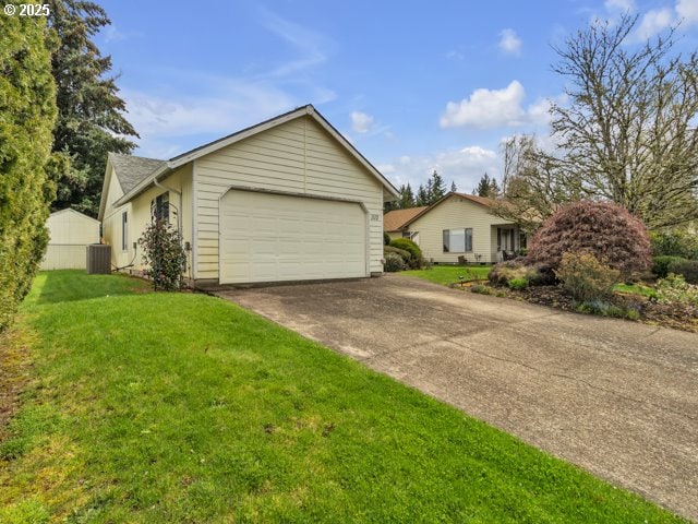 view of front of house with central AC unit, a front yard, an attached garage, and concrete driveway