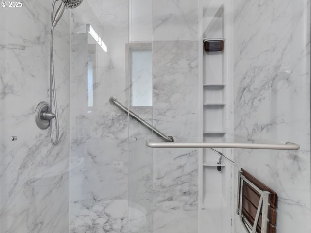 bathroom with a marble finish shower