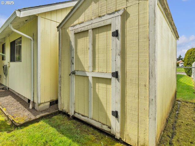 view of shed featuring fence